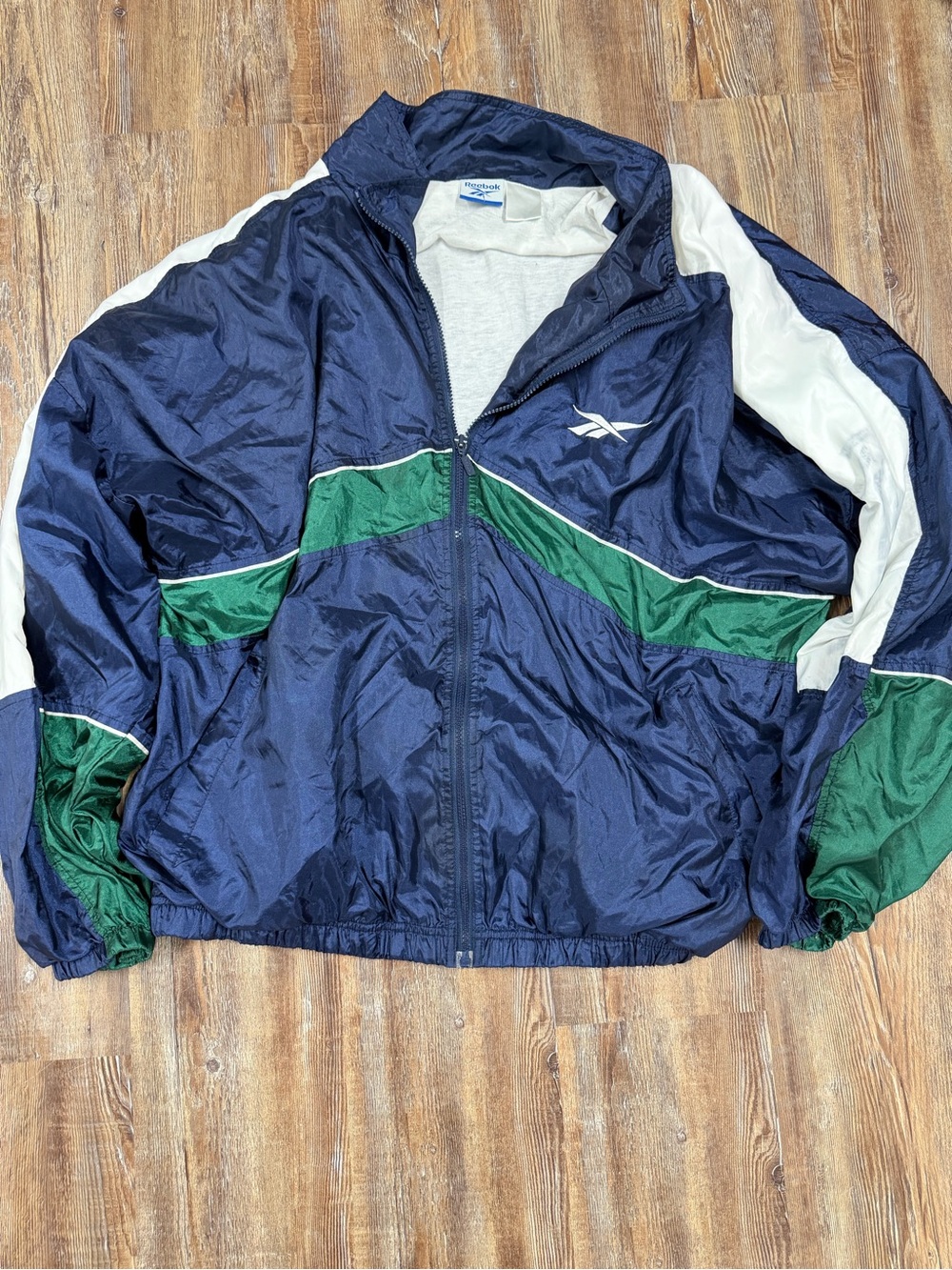 Vintage 90s Reebok windbreaker jacket with white and green panels on navy blue